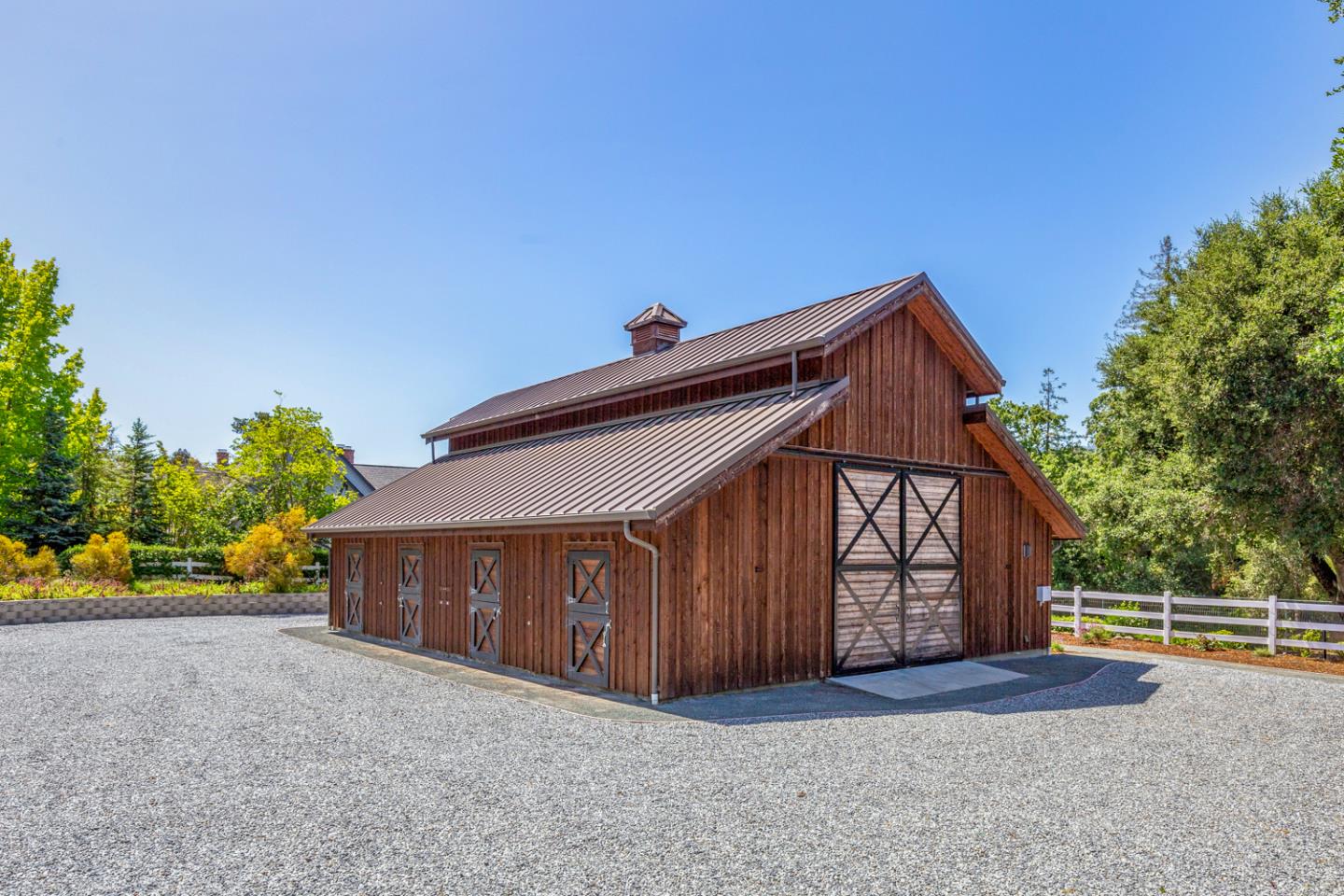 1210 Cañada Road Woodside, CA 94062 - Photo 45 of 60 a view of an house with backyard and trees