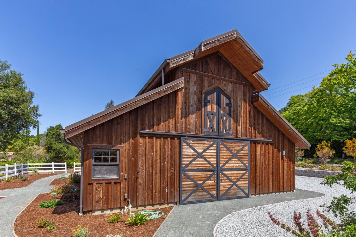1210 Cañada Road Woodside, CA 94062 - Photo 46 of 60 a front view of a house with garden