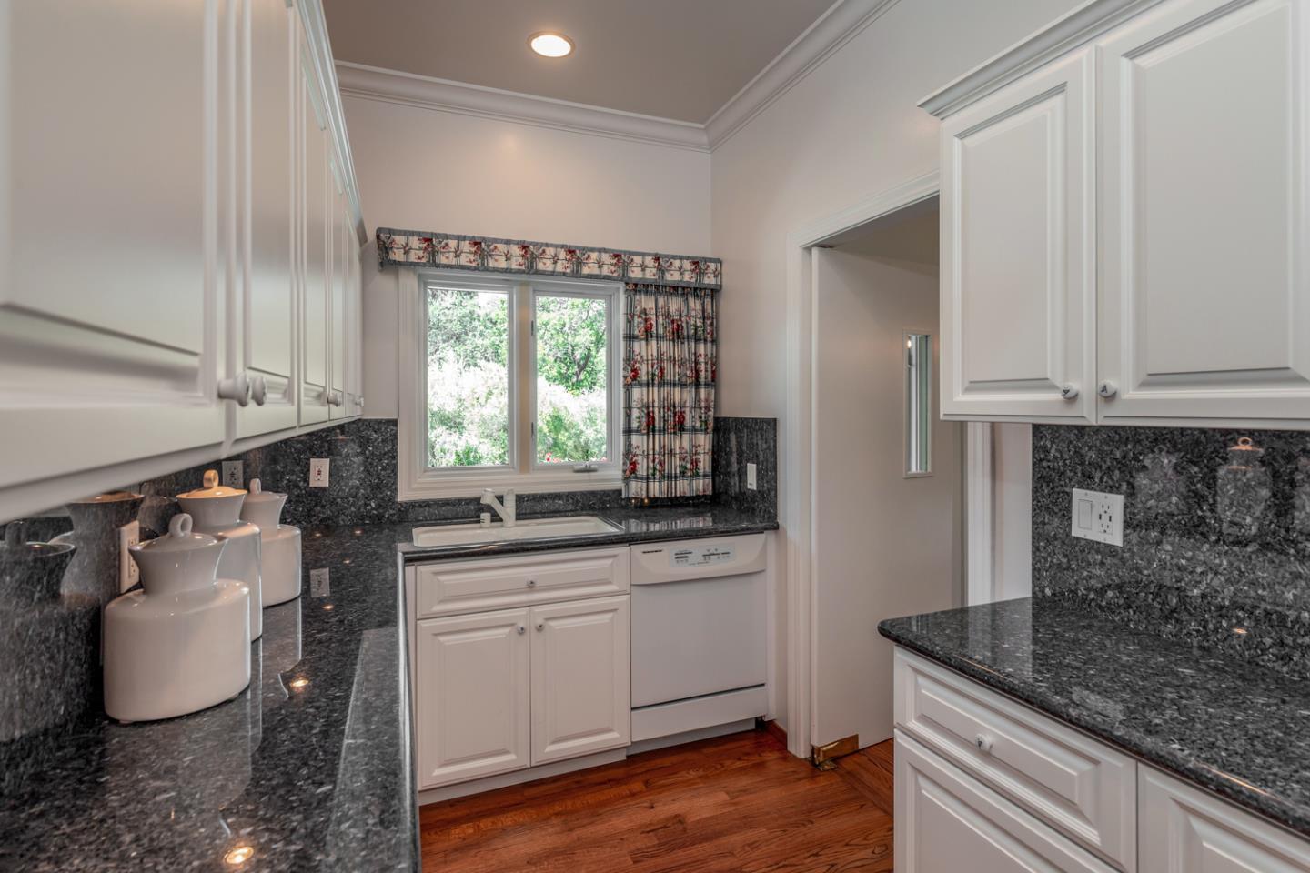 1210 Cañada Road Woodside, CA 94062 - Photo 8 of 60 a kitchen with granite countertop a sink and a stove
