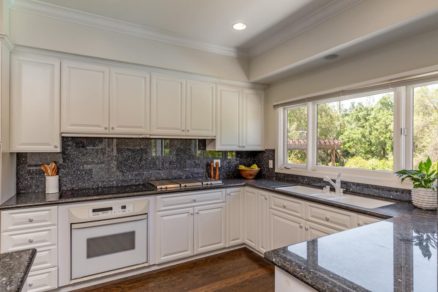 1210 Cañada Road Woodside, CA 94062 - Photo 10 of 60 a kitchen with stainless steel appliances white cabinets a sink and a stove