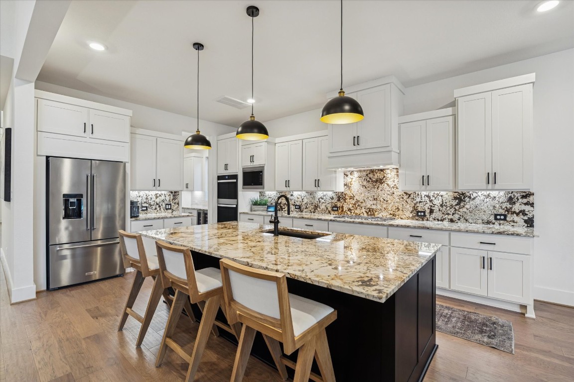 4118 Pleasant Ridge Drive Spring, TX 77386 - Photo 18 of 50 Class 9 Exotic Granite countertops and backsplash. Additional Modern Pendant Lights, Recessed Lighting & Under Cabinet Lighting