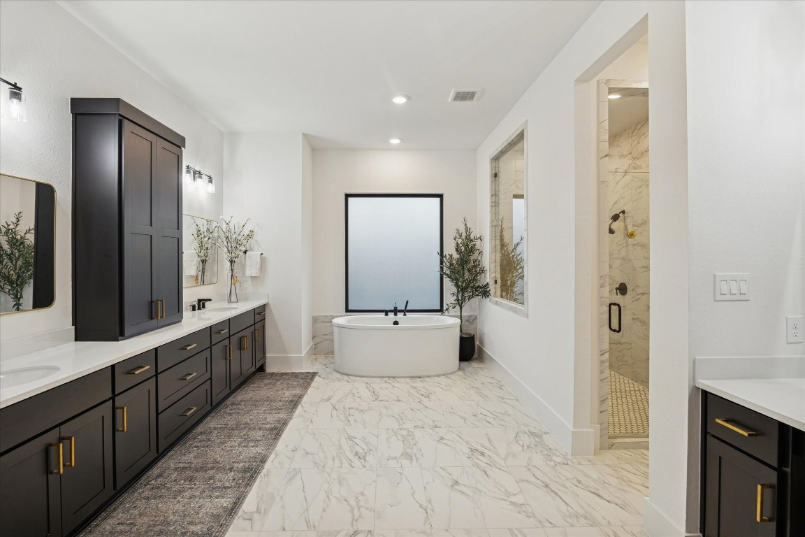 4118 Pleasant Ridge Drive Spring, TX 77386 - Photo 29 of 50 *EXTENDED* Primary Bathroom upgrade. Looks and feels like a Model Home with all of the UPGRADES including all of the bathroom fixtures, light fixtures, mirrors, built-out vanity, modern soaking tub & more.