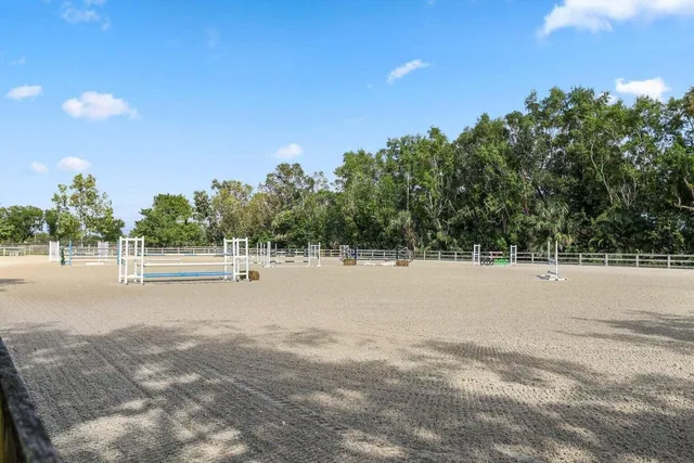 a view of swimming pool with a lake and trees in the background
