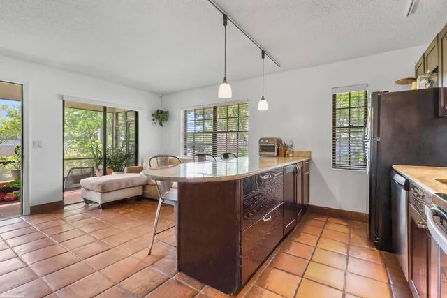 a view of a patio with chairs and potted plants