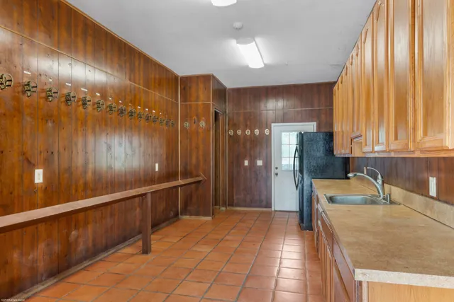 a bathroom with a sink a large mirror and a shower