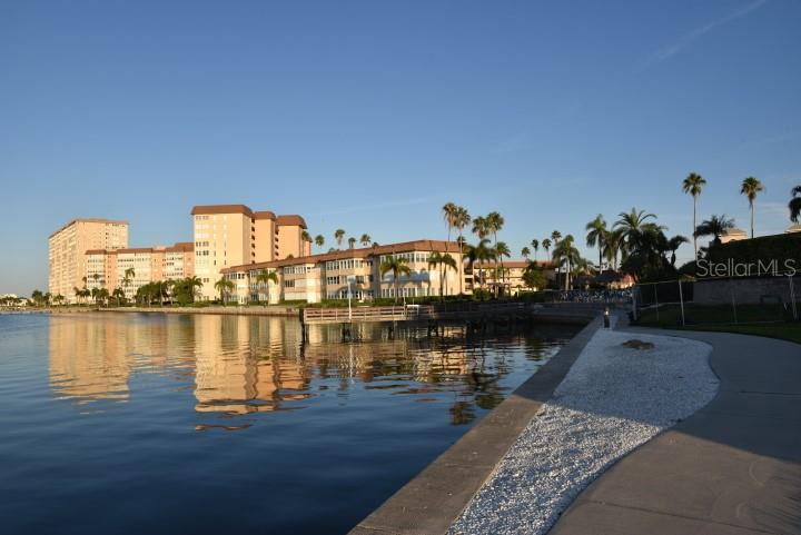 a view of a ocean with boats and trees in the background