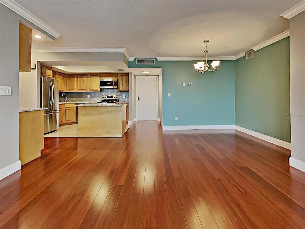5220 Brittany Drive South, Unit 1502 St. Petersburg, FL 33715 - Photo 11 of 21 a view of a kitchen with wooden floor