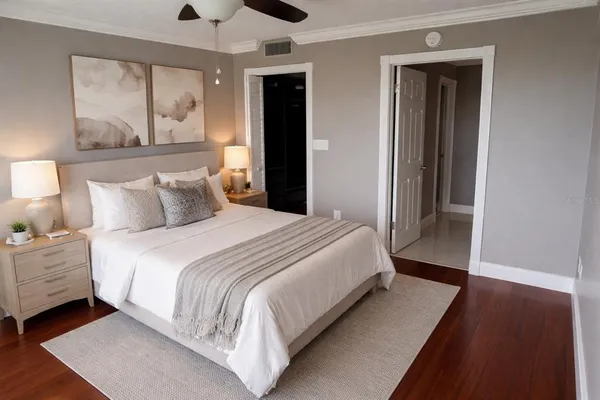 a bedroom with a bed and a painting on the wall