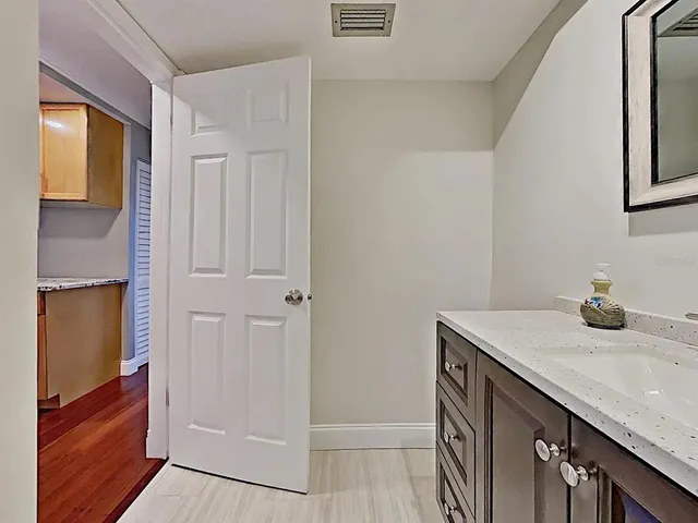 a bathroom with a sink a vanity and a mirror