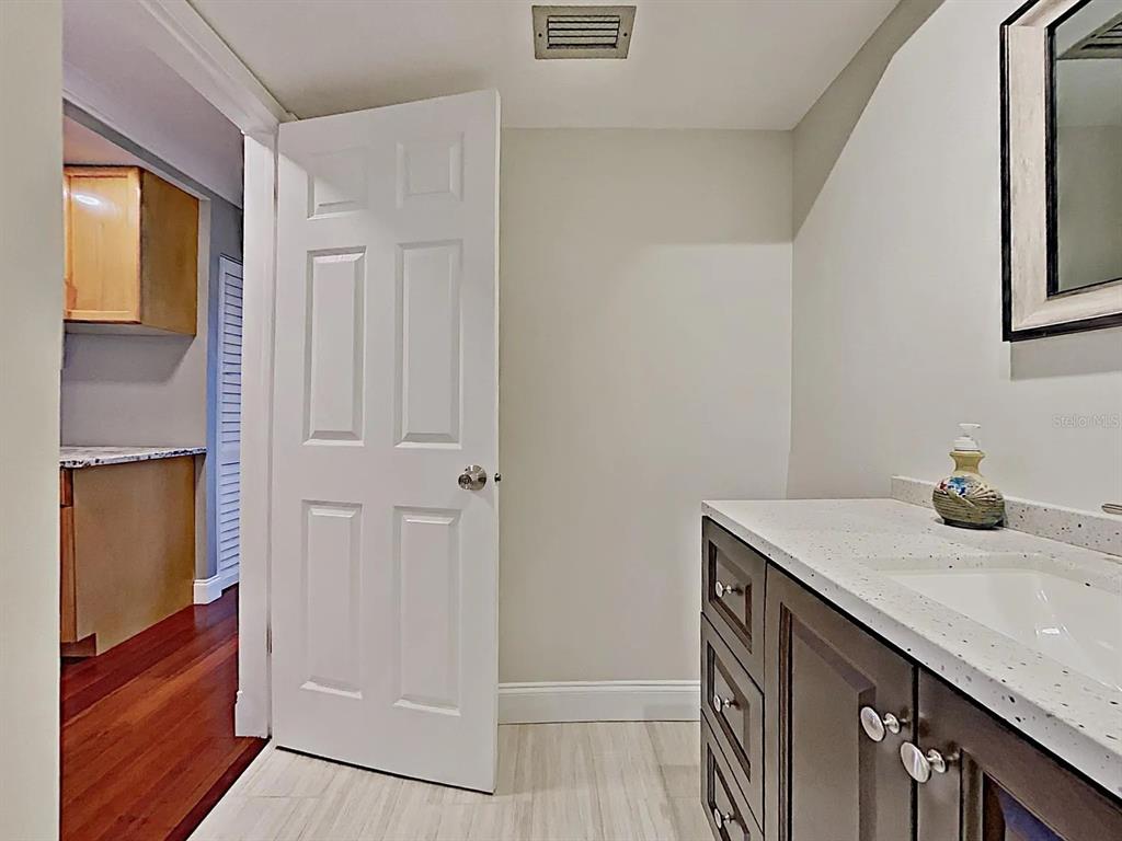 5220 Brittany Drive South, Unit 1502 St. Petersburg, FL 33715 - Photo 16 of 21 a bathroom with a sink a vanity and a mirror
