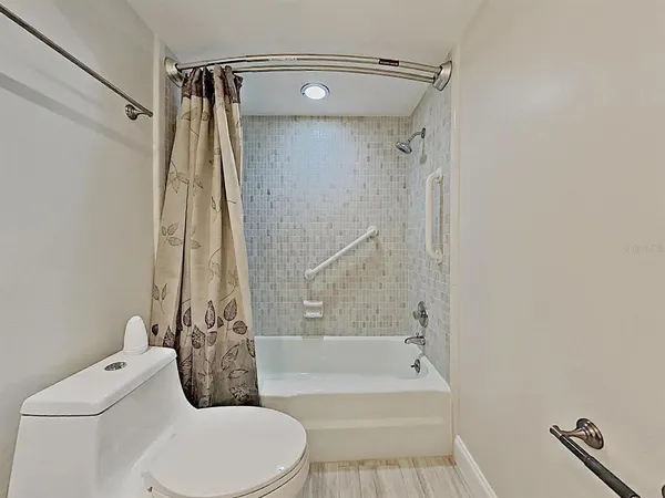 a bathroom with a toilet and a shower