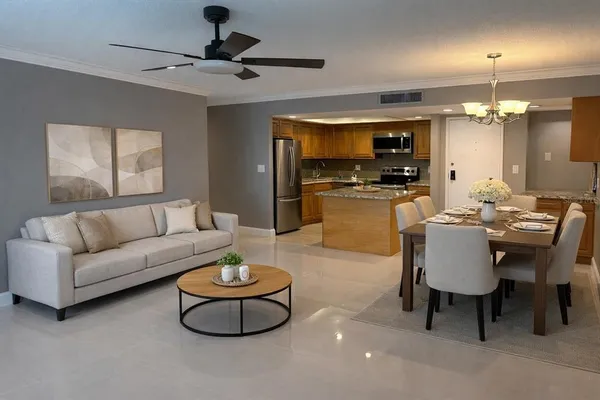 a living room with furniture a chandelier and a flat screen tv
