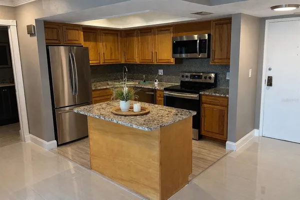 a kitchen with a refrigerator stove and sink