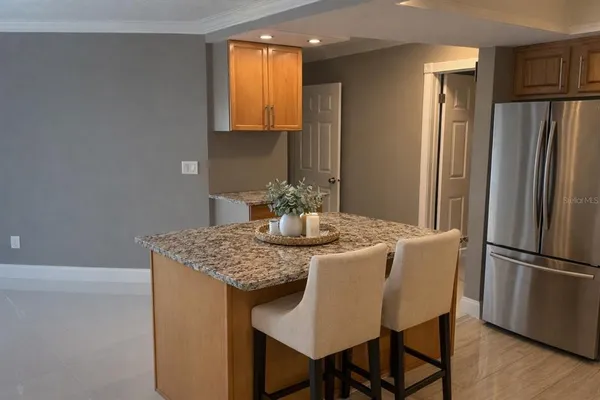 a dining table with chairs and refrigerator