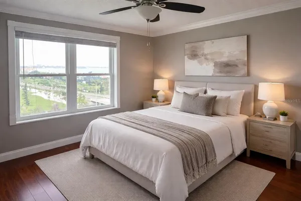 a bedroom with a bed and a painting on the wall