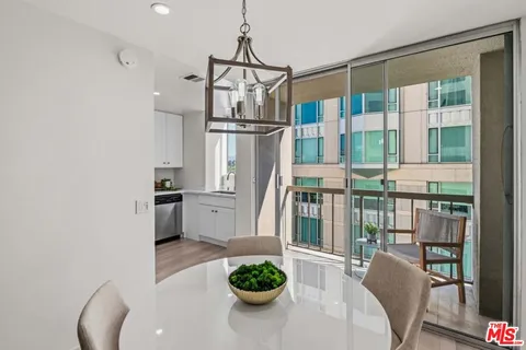 a kitchen with stainless steel appliances a refrigerator a sink a stove and white cabinets