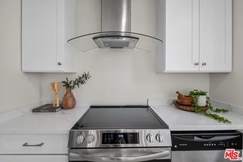 a kitchen with a stove and cabinets