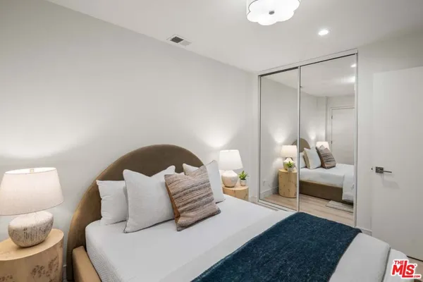 a bedroom with a bed and window