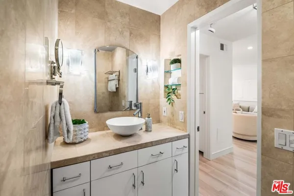 a bathroom with a sink a mirror and a shower