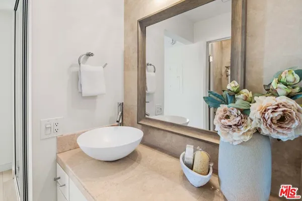 a bathroom with a sink mirror and vanity