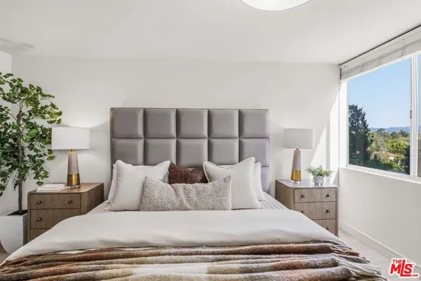 a large white bed in a white room