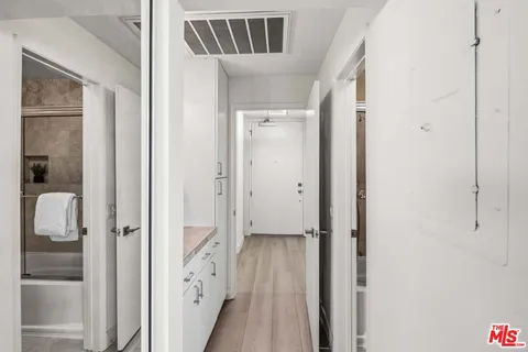 a view of an entryway with wooden floor