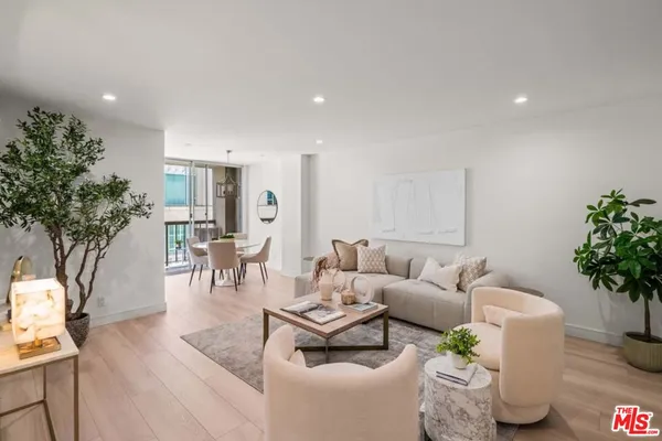 a living room with furniture and flowers