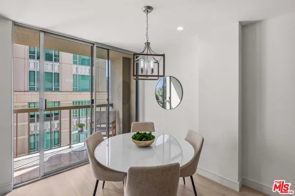 a dining room with furniture a chandelier and wooden floor