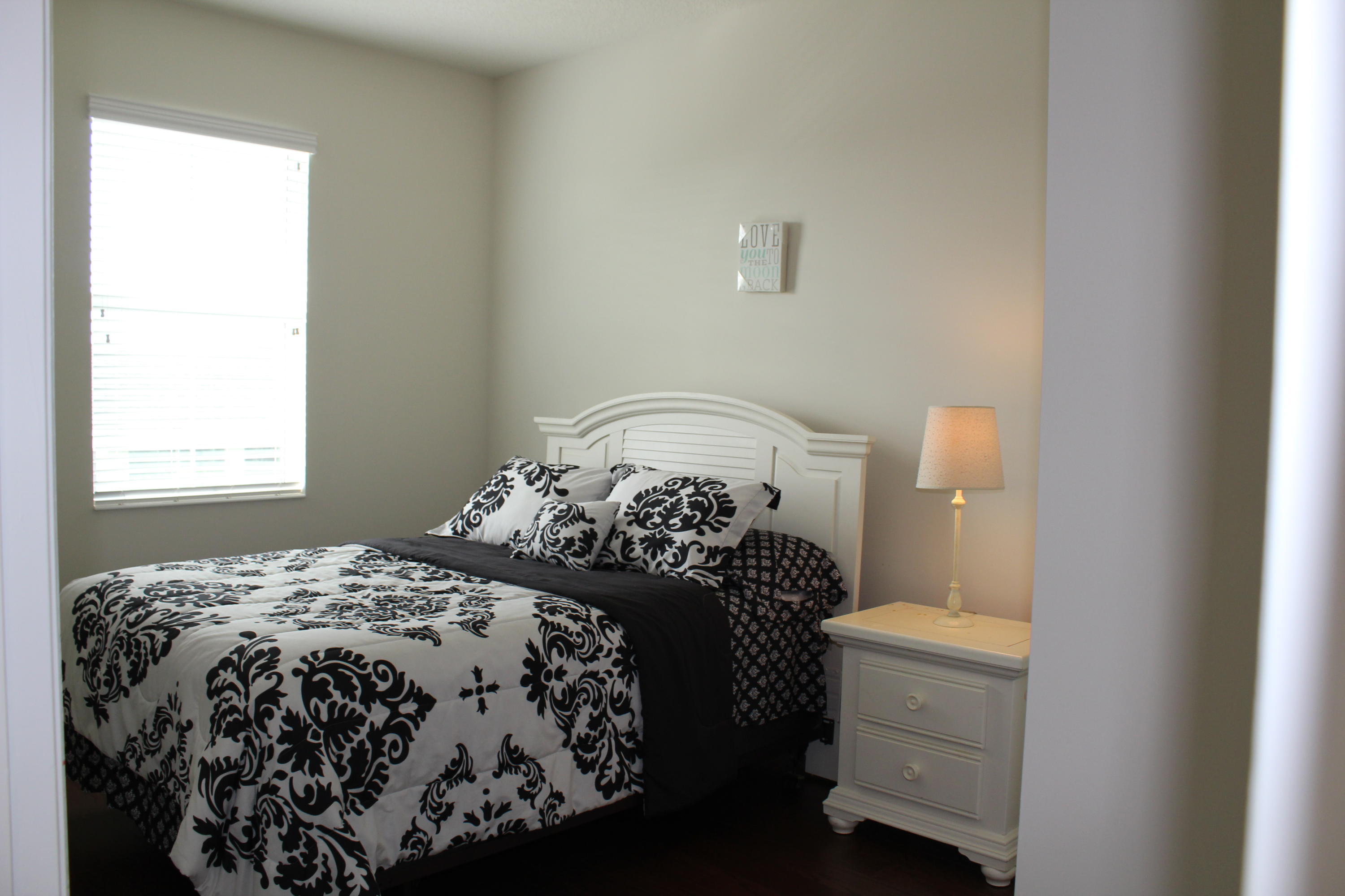 1168 South Community Drive Jupiter, FL 33458 - Photo 11 of 18 a bedroom with a bed and a window