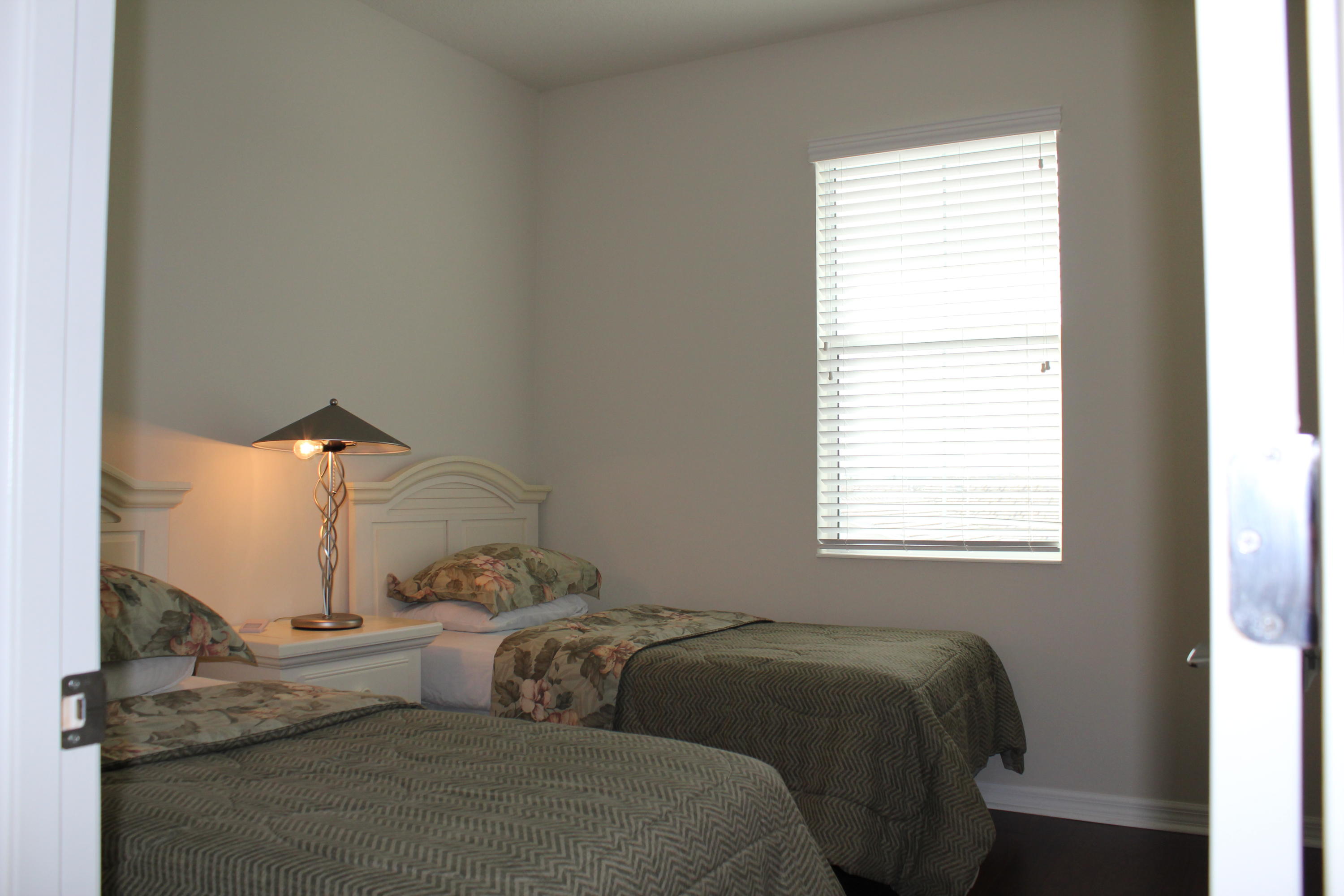 1168 South Community Drive Jupiter, FL 33458 - Photo 12 of 18 a bedroom with a bed and a window