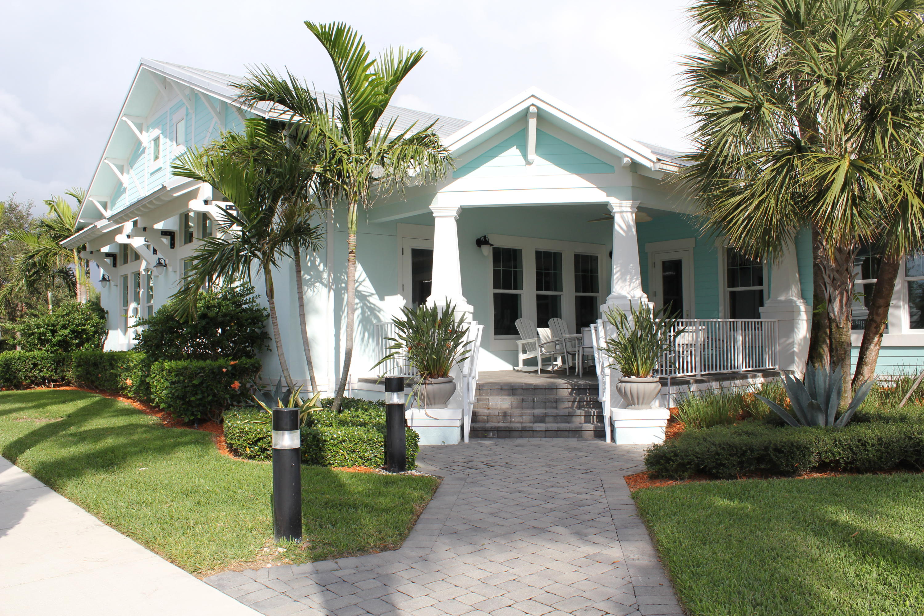 1168 South Community Drive Jupiter, FL 33458 - Photo 16 of 18 a view of a house with a yard and potted plants