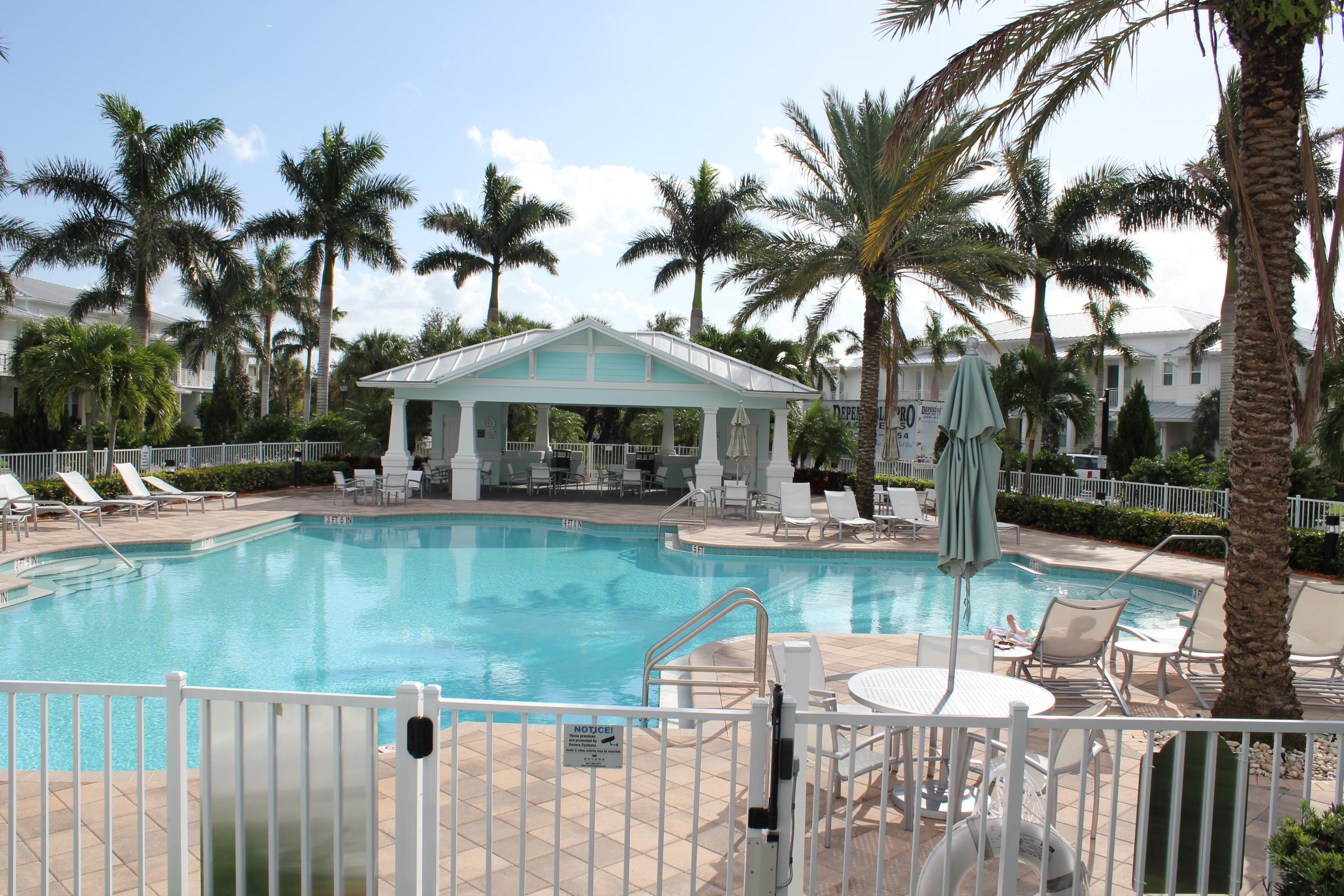 1168 South Community Drive Jupiter, FL 33458 - Photo 17 of 18 a view of a house with swimming pool and a porch with furniture