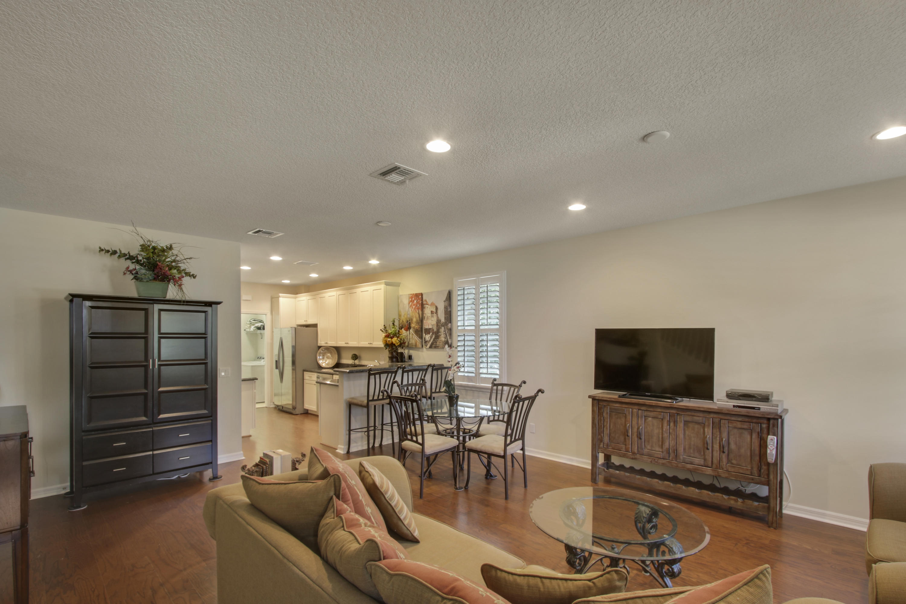 1168 South Community Drive Jupiter, FL 33458 - Photo 3 of 18 a view of a livingroom with furniture and a flat screen tv
