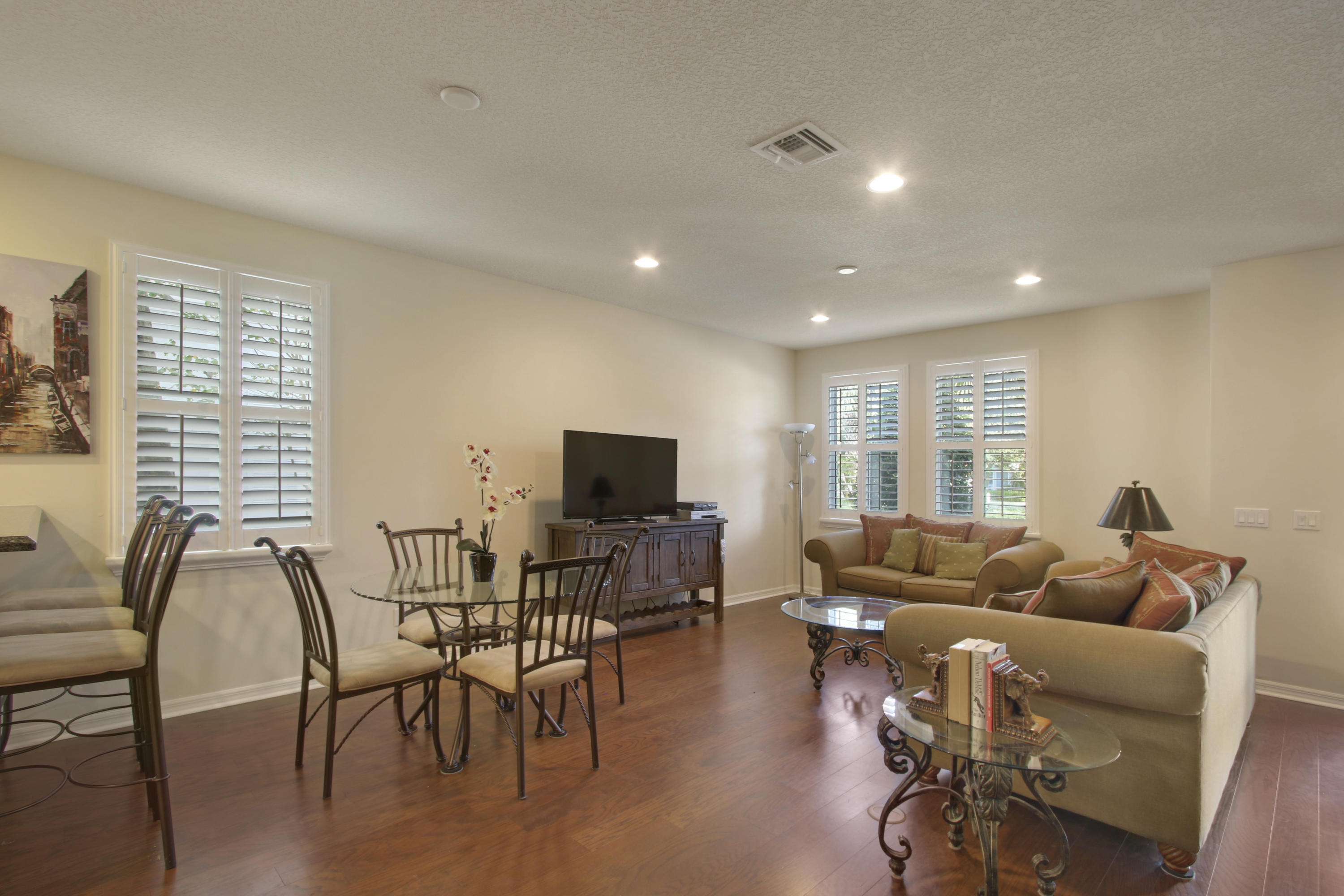 1168 South Community Drive Jupiter, FL 33458 - Photo 5 of 18 a living room with furniture a flat screen tv and wooden floor