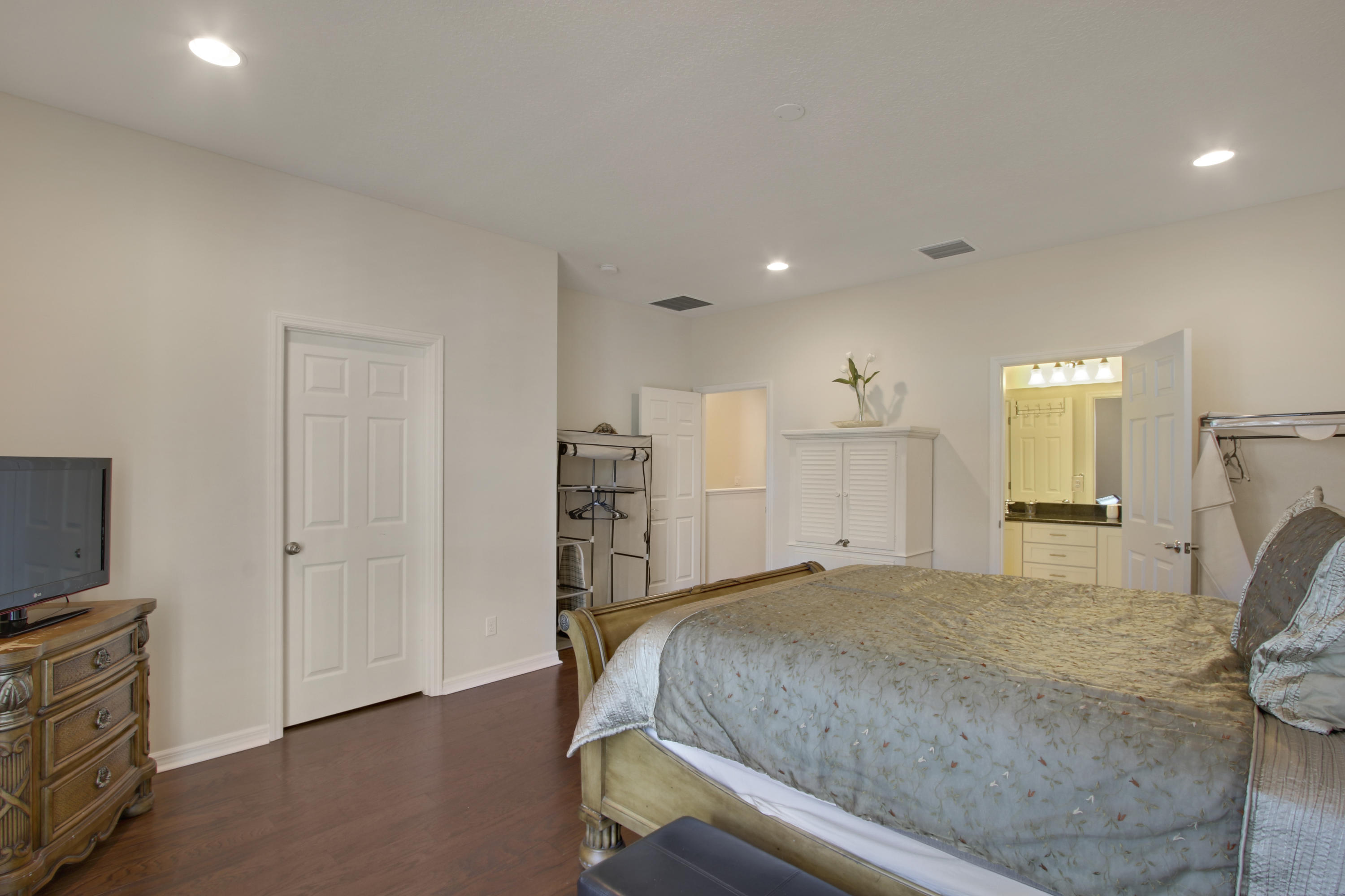 1168 South Community Drive Jupiter, FL 33458 - Photo 9 of 18 a bedroom with a bed and a television