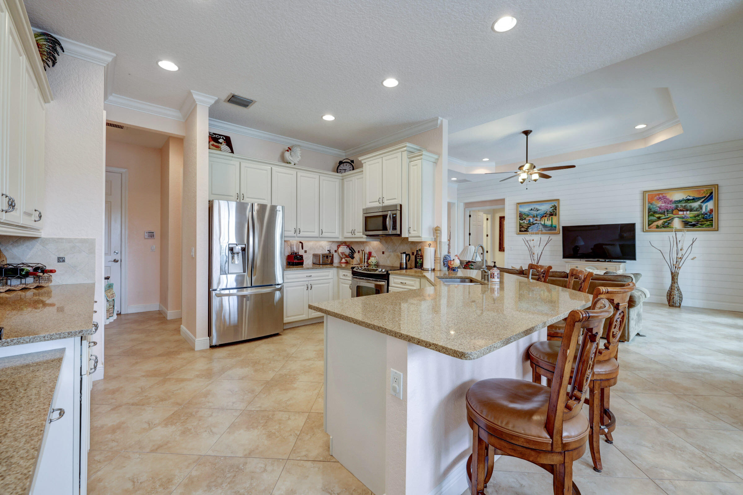 571 Southeast Tres Belle Circle Stuart, FL 34997 - Photo 12 of 54 a kitchen with stainless steel appliances granite countertop a sink a stove a refrigerator and cabinets
