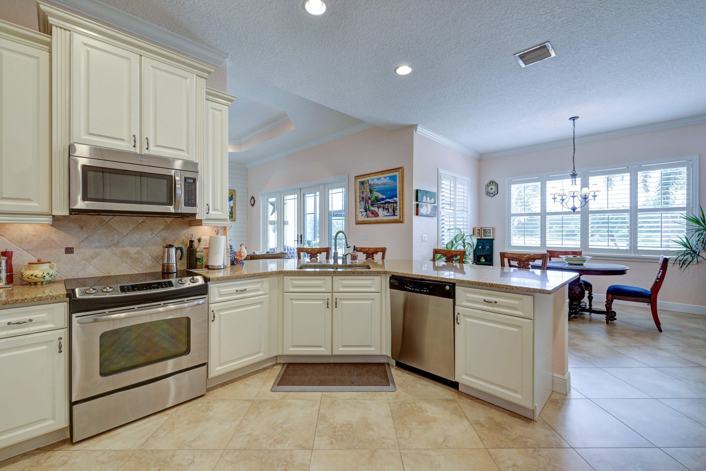 571 Southeast Tres Belle Circle Stuart, FL 34997 - Photo 13 of 54 a kitchen with appliances a sink and cabinets