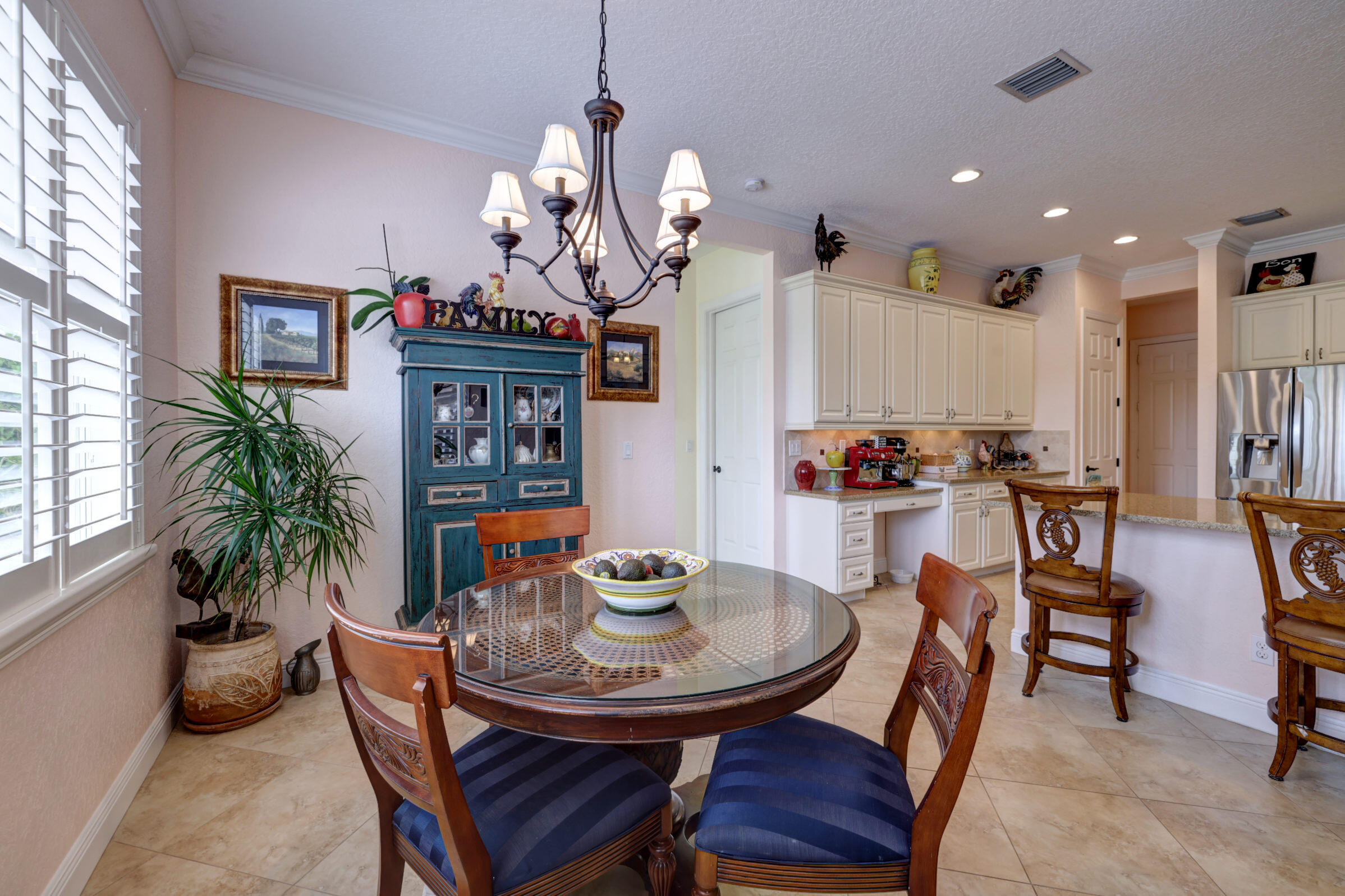 571 Southeast Tres Belle Circle Stuart, FL 34997 - Photo 16 of 54 a view of a dining room with furniture and a chandelier