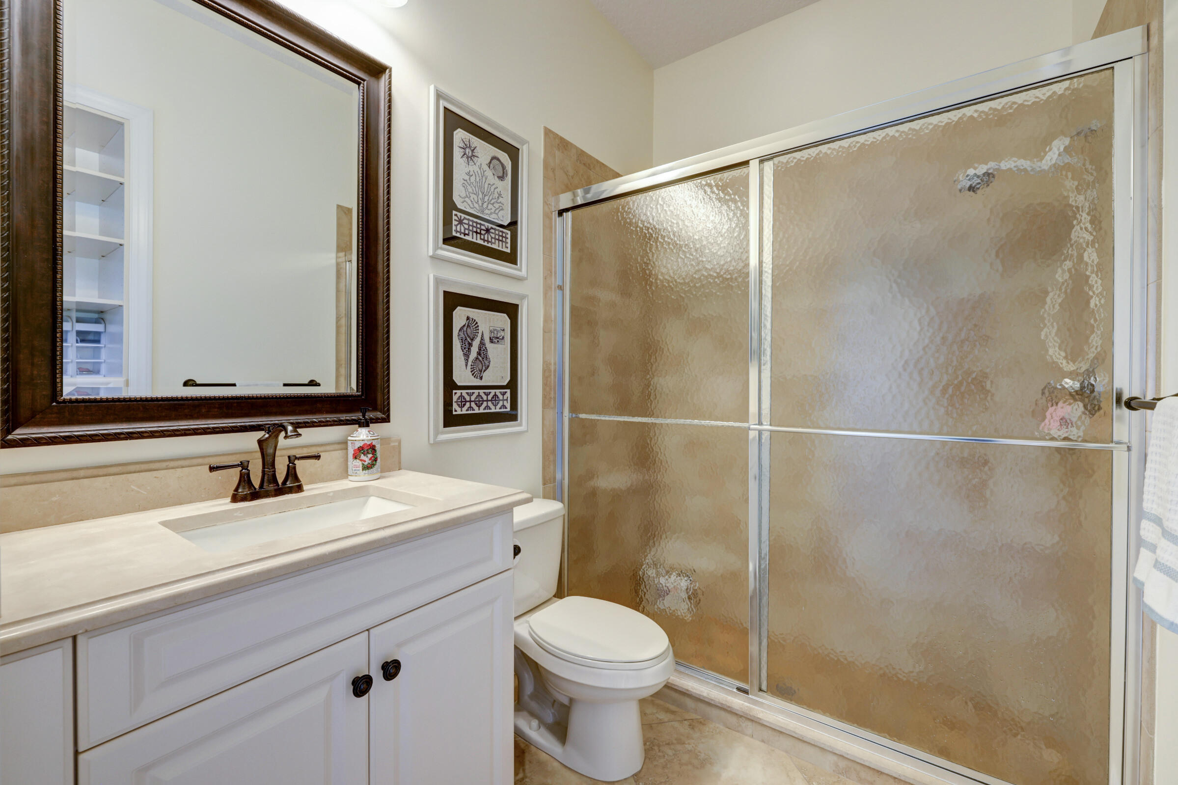 571 Southeast Tres Belle Circle Stuart, FL 34997 - Photo 17 of 54 a bathroom with a sink toilet and shower