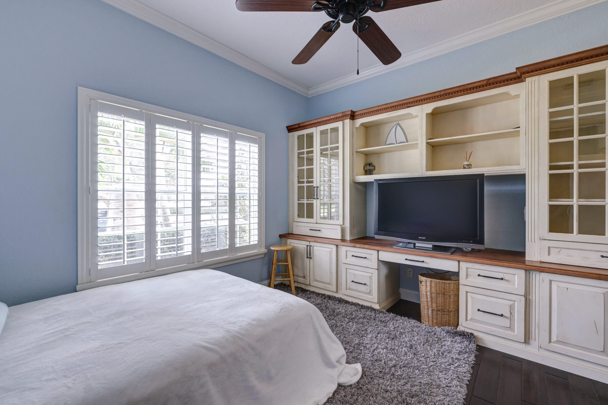 571 Southeast Tres Belle Circle Stuart, FL 34997 - Photo 20 of 54 a bedroom with a bed and a flat screen tv