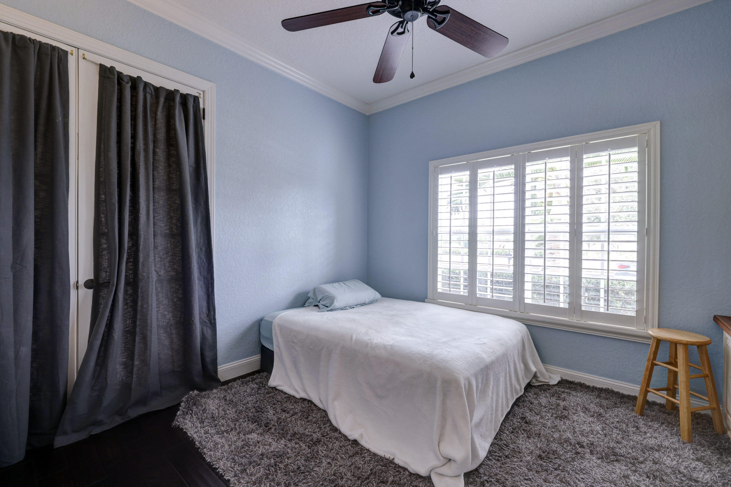 571 Southeast Tres Belle Circle Stuart, FL 34997 - Photo 21 of 54 a bedroom with a bed and a window