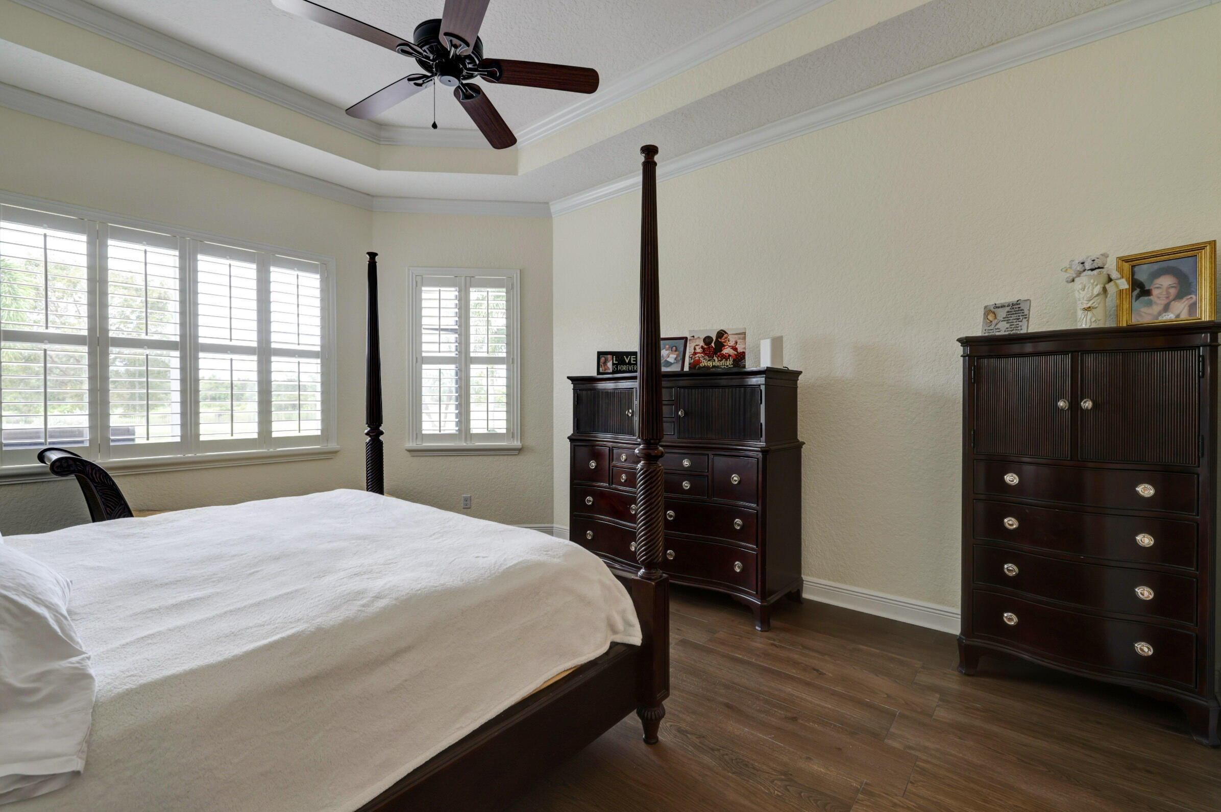 571 Southeast Tres Belle Circle Stuart, FL 34997 - Photo 24 of 54 a bedroom with a bed a dresser and a window