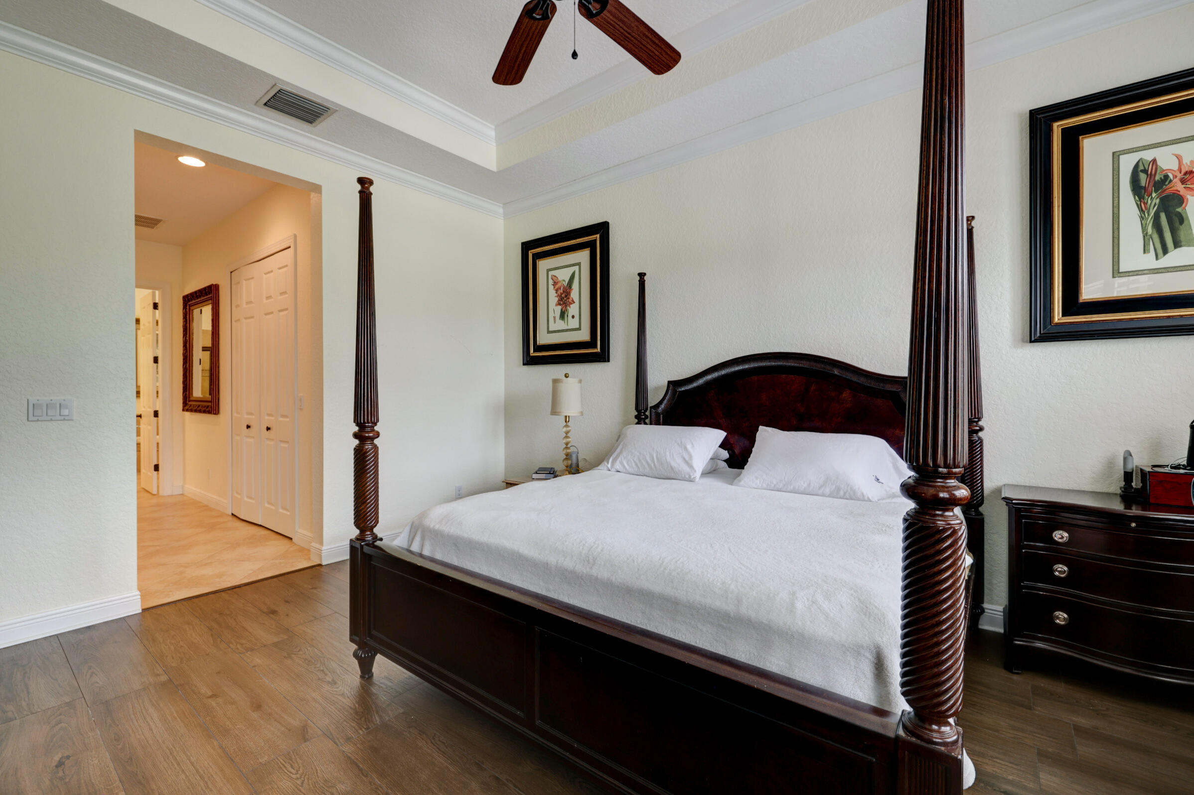 571 Southeast Tres Belle Circle Stuart, FL 34997 - Photo 25 of 54 a bedroom with a bed and wooden floor