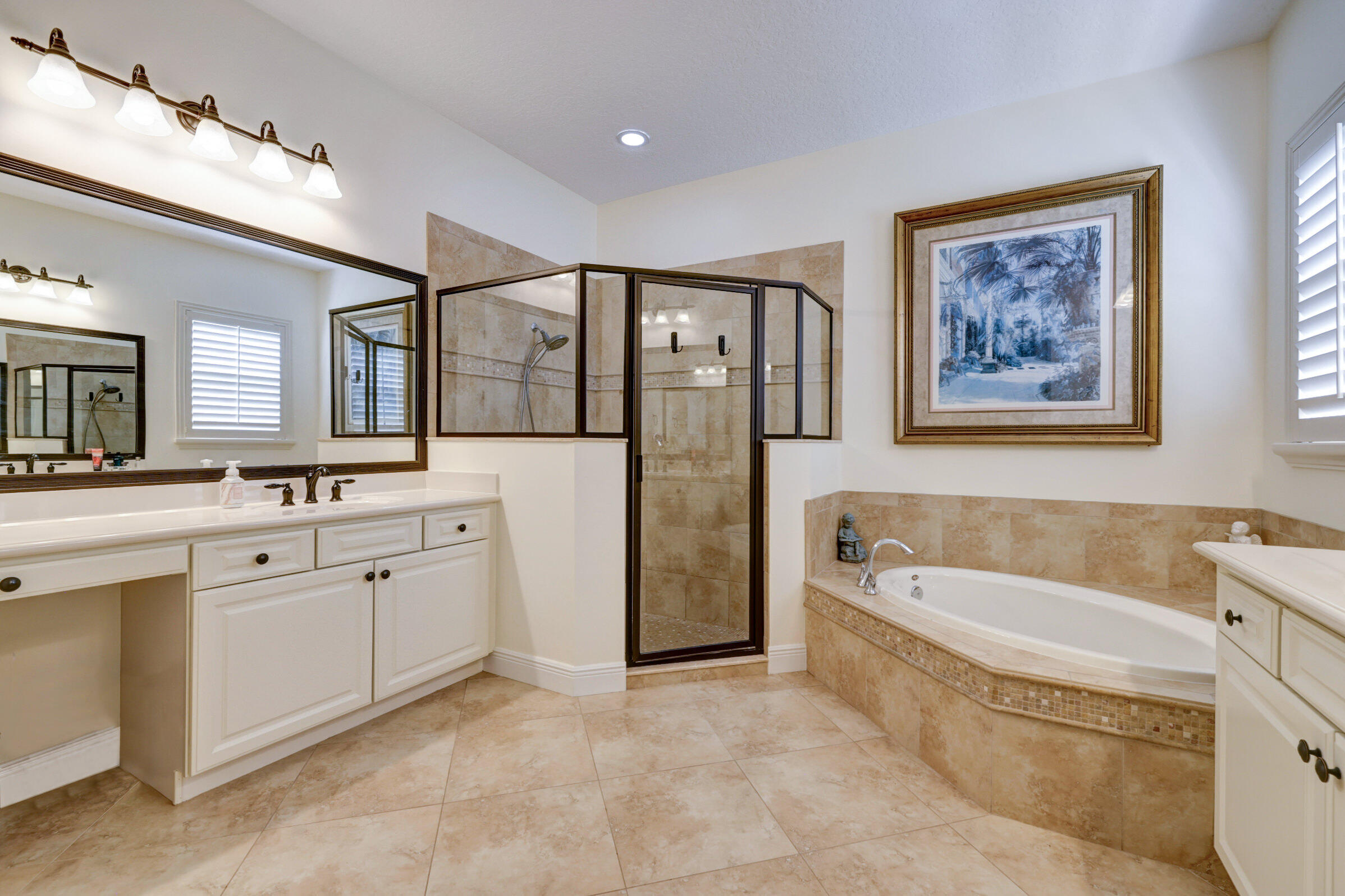 571 Southeast Tres Belle Circle Stuart, FL 34997 - Photo 27 of 54 a spacious bathroom with a tub sink and mirror