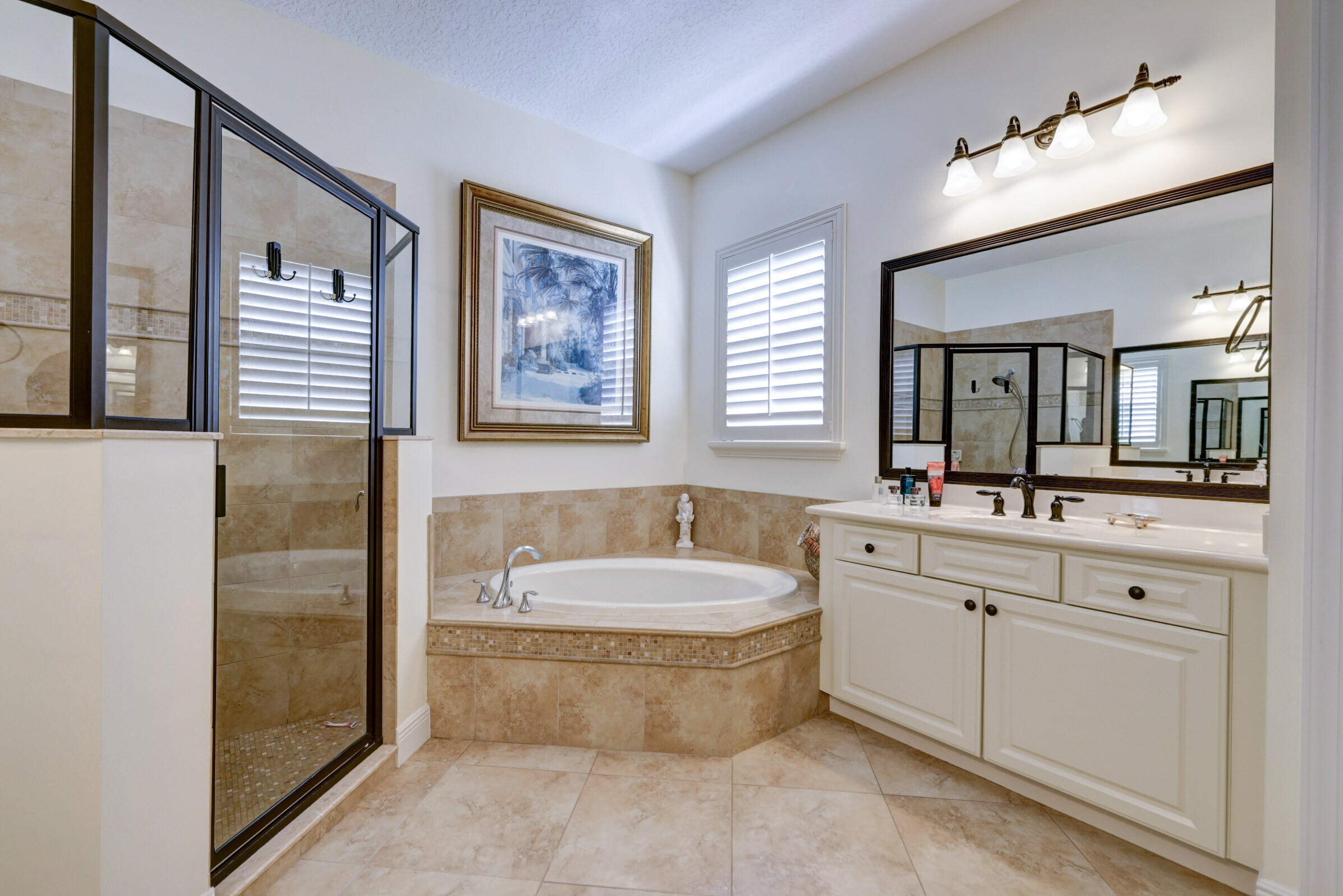 571 Southeast Tres Belle Circle Stuart, FL 34997 - Photo 28 of 54 a spacious bathroom with a tub sink and mirror