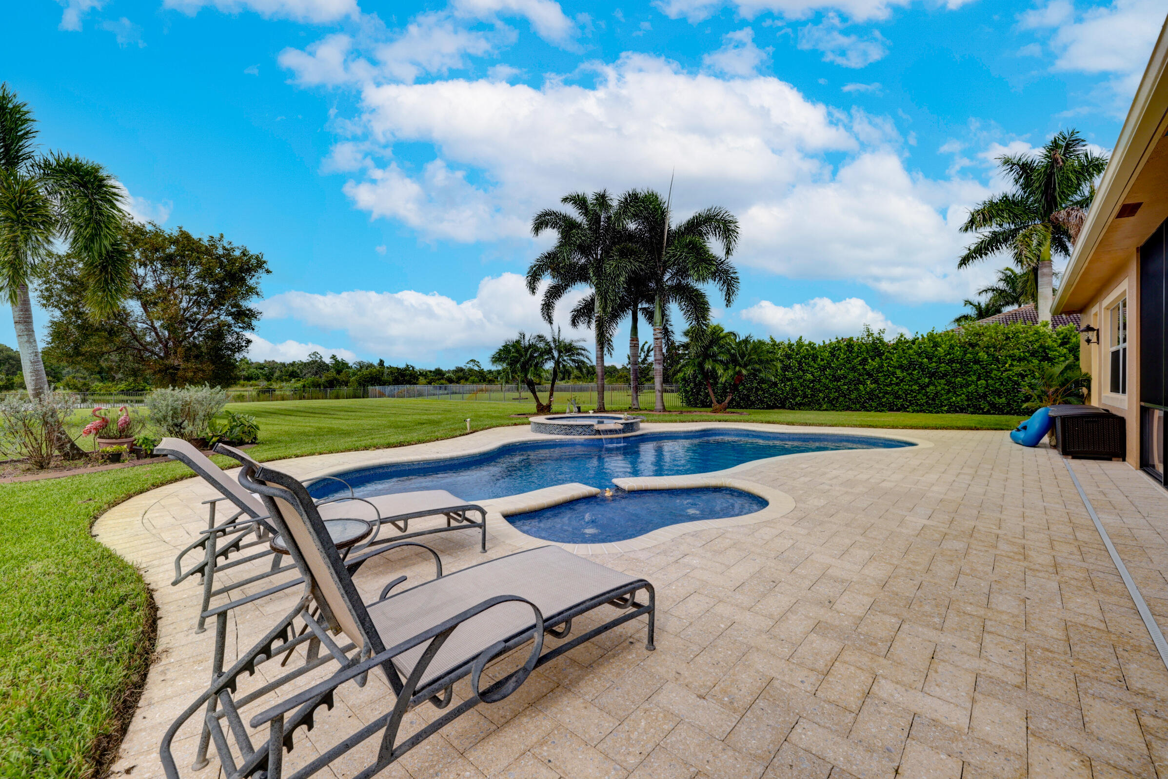571 Southeast Tres Belle Circle Stuart, FL 34997 - Photo 33 of 54 a view of swimming pool with outdoor seating and plants