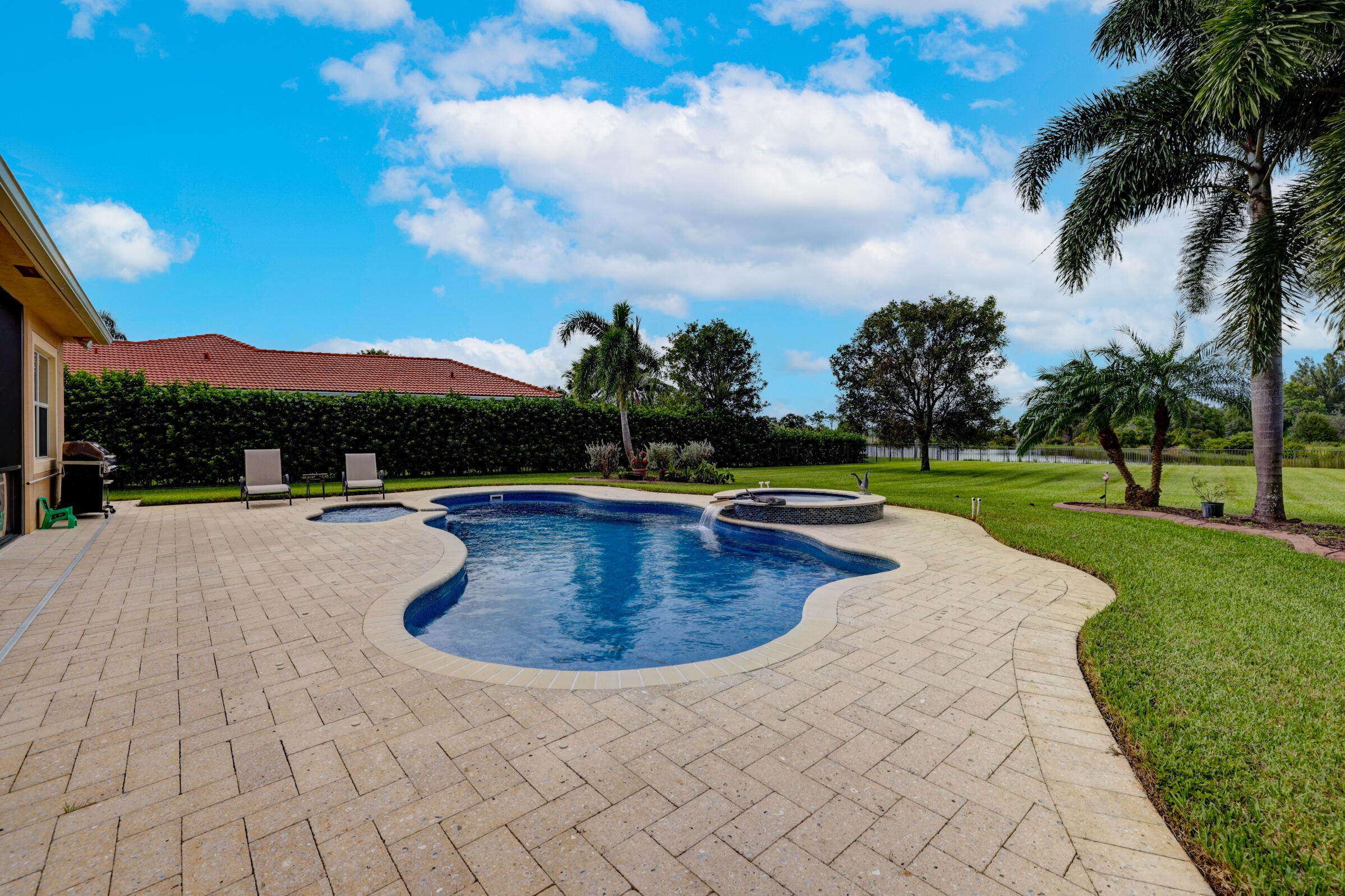 571 Southeast Tres Belle Circle Stuart, FL 34997 - Photo 35 of 54 a view of swimming pool with a garden and mountain view