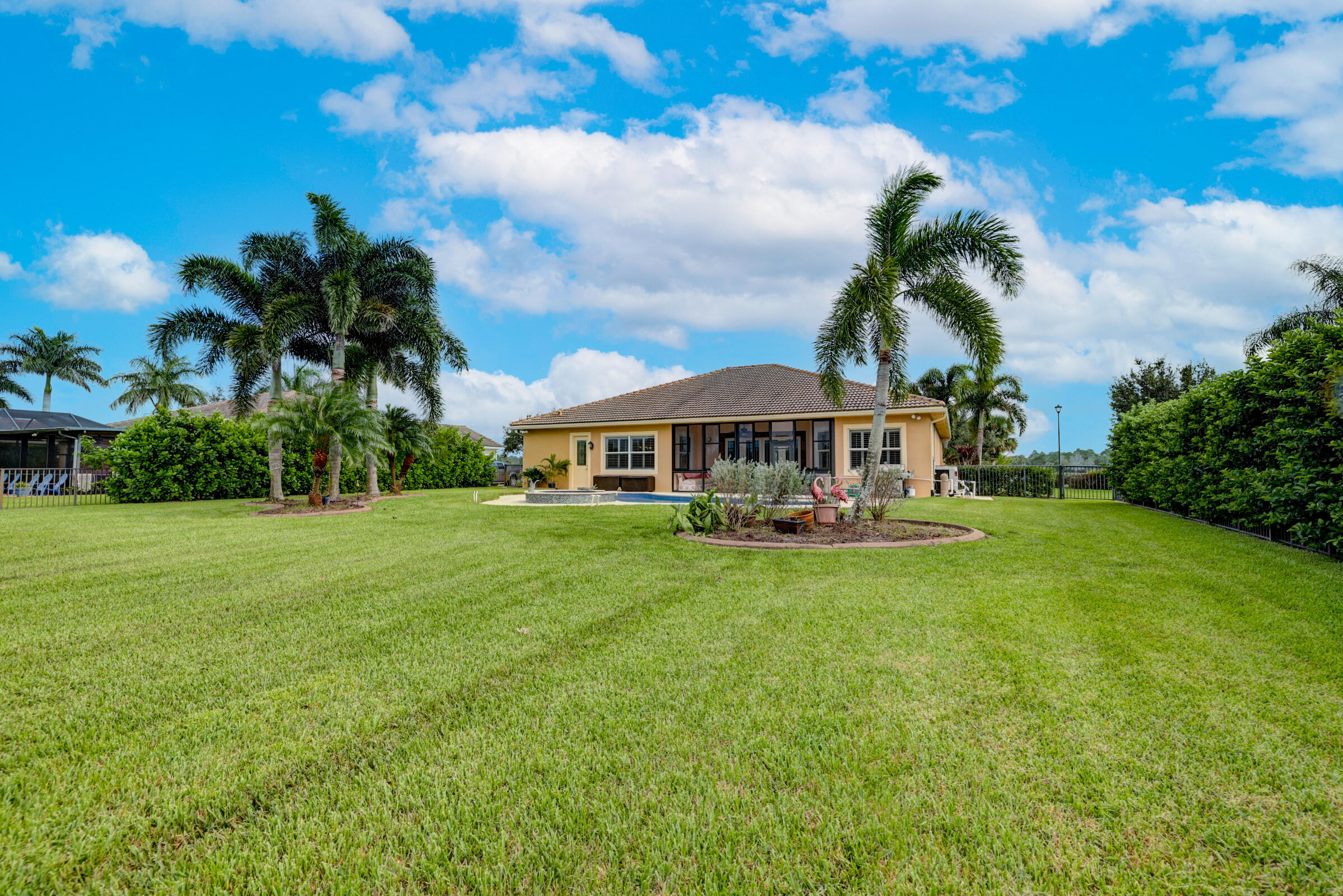 571 Southeast Tres Belle Circle Stuart, FL 34997 - Photo 39 of 54 a front view of a house with garden