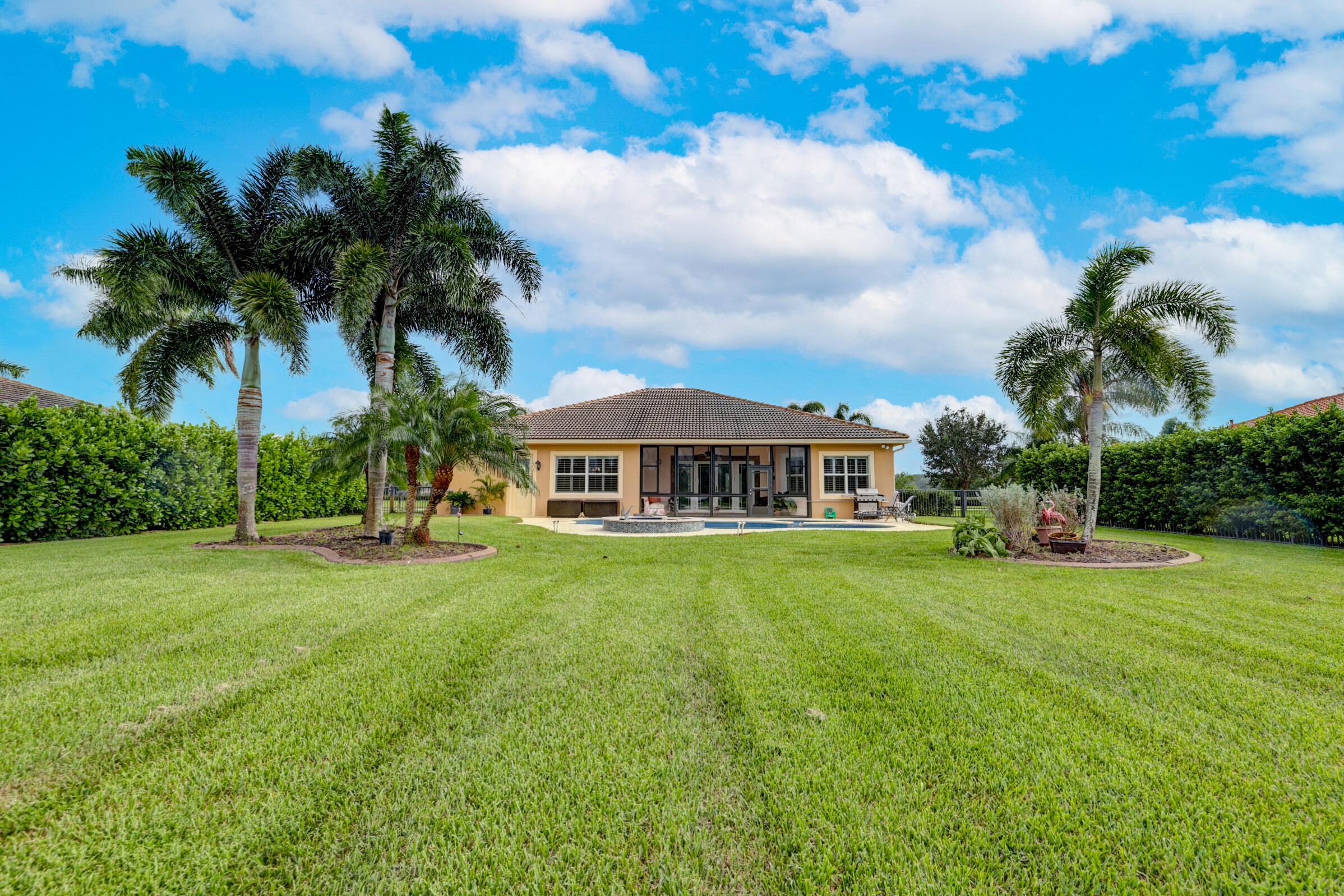 571 Southeast Tres Belle Circle Stuart, FL 34997 - Photo 40 of 54 a view of a big yard with a house in the background