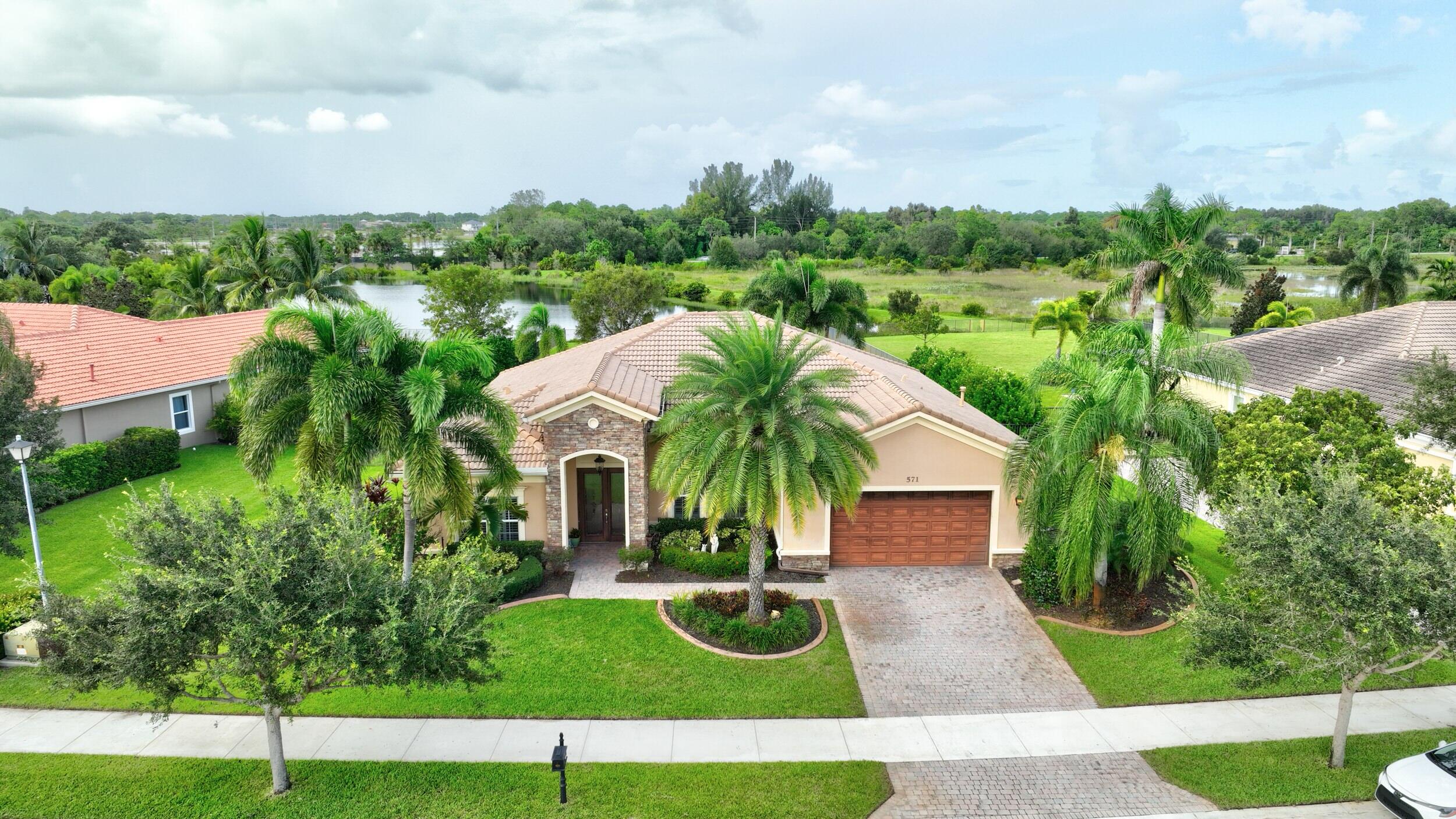 571 Southeast Tres Belle Circle Stuart, FL 34997 - Photo 43 of 54 a view of a house with a yard